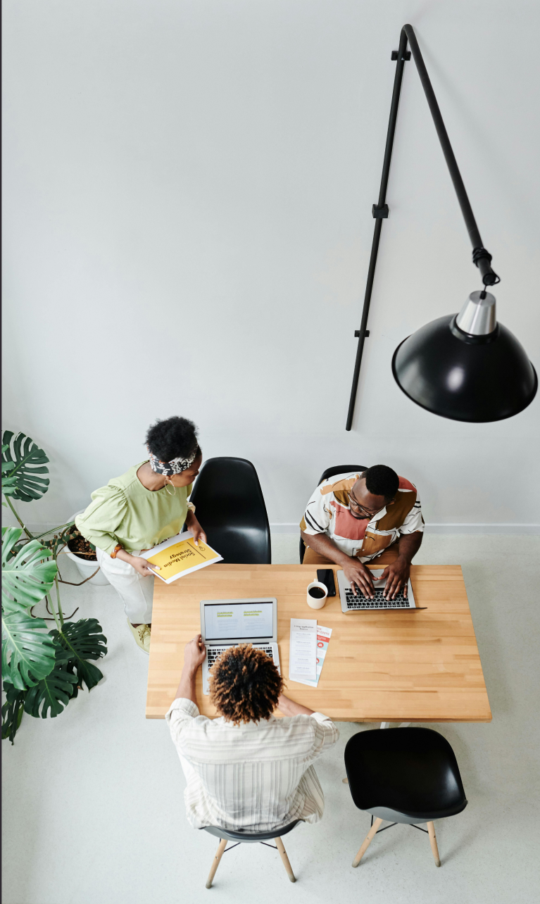 Team of people at desk working together