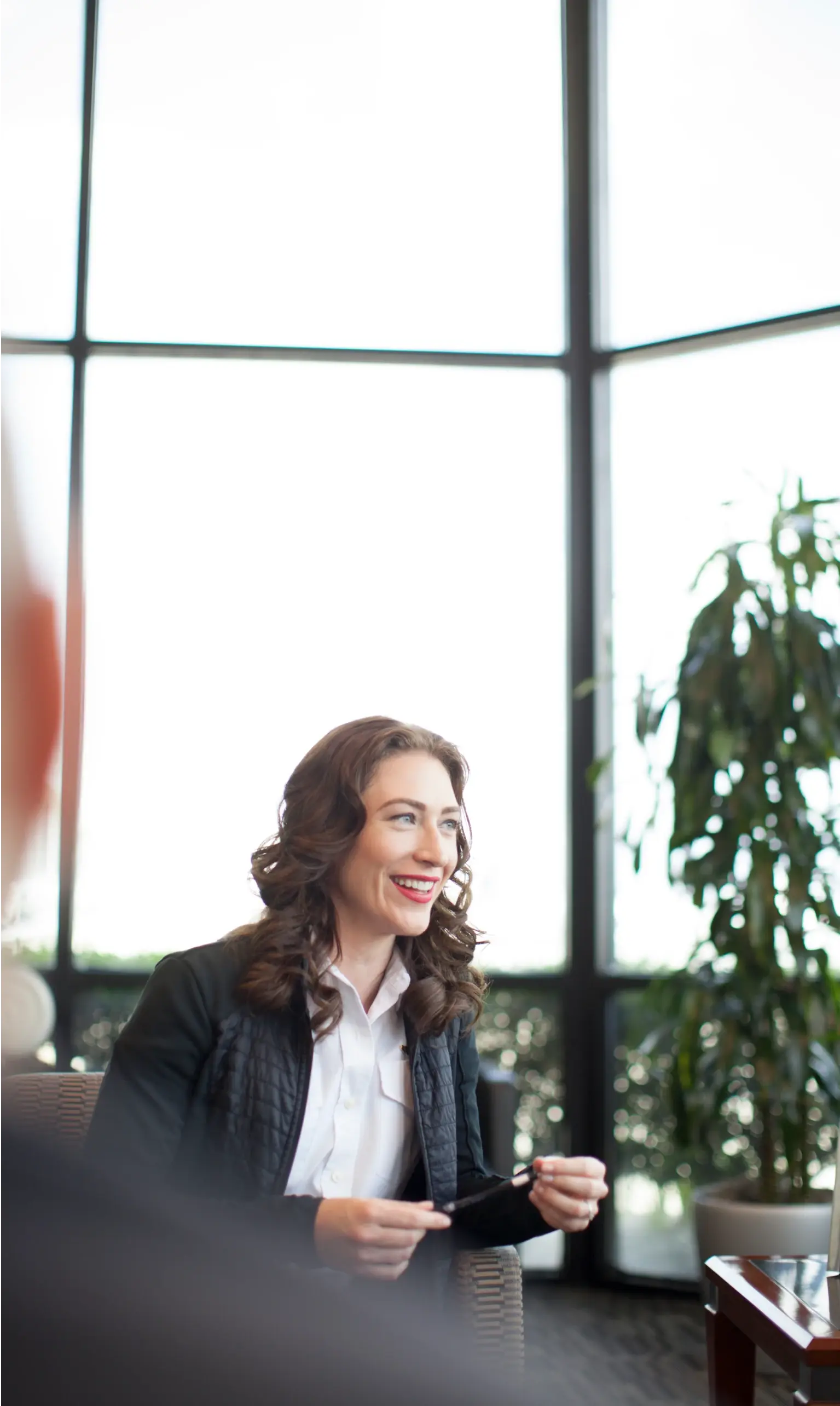 Business woman sitting in trendy office with co workers