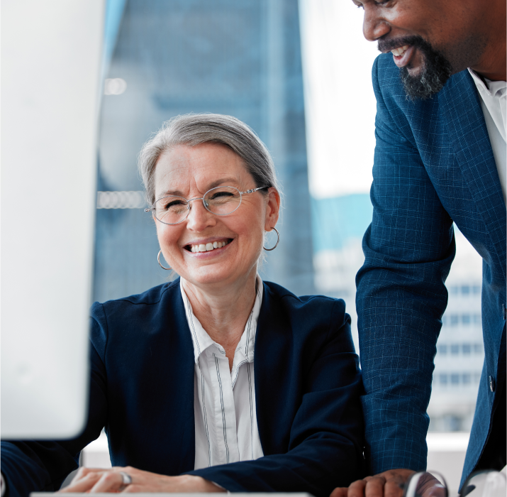 Governemt woman working at computer with co worker