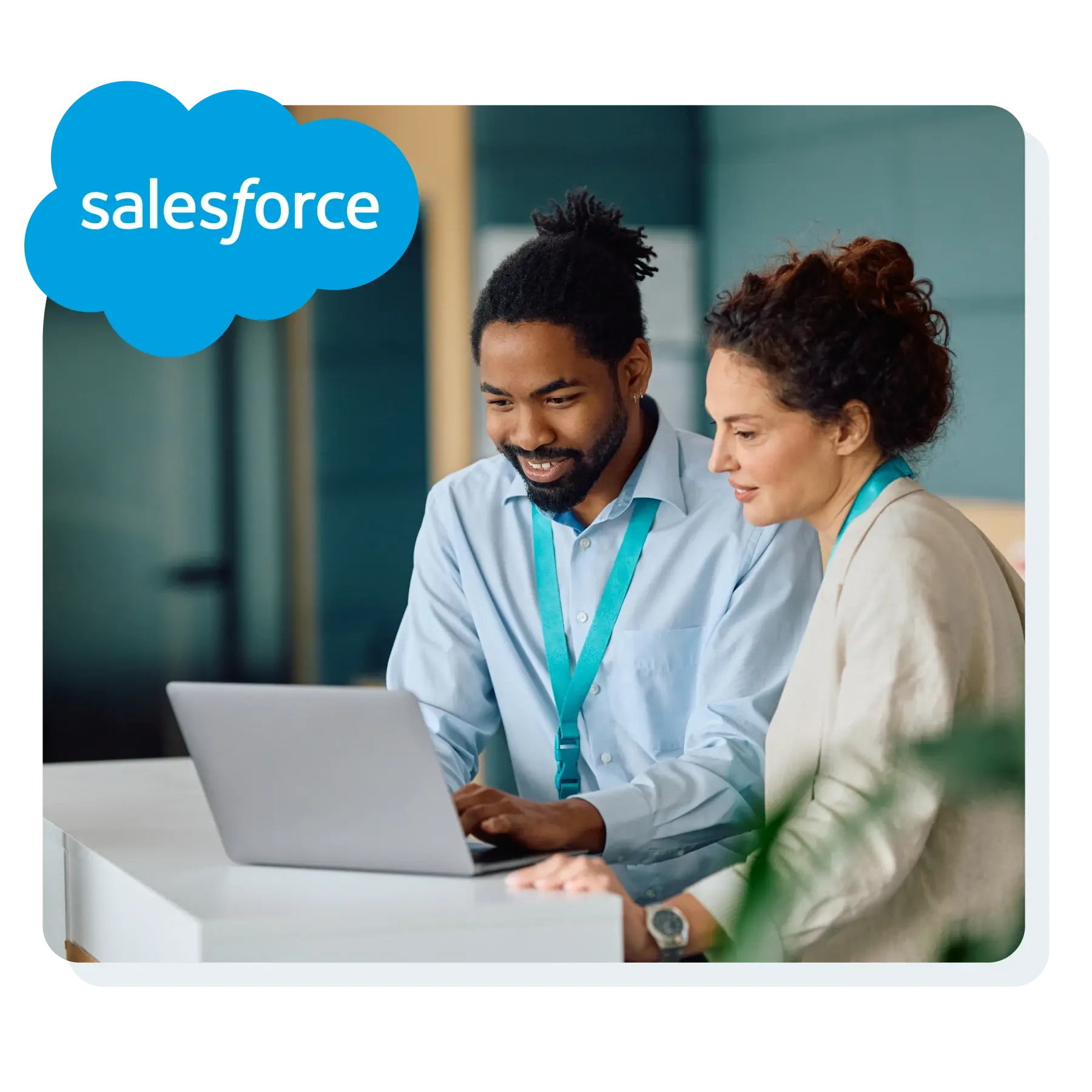 Man and woman looking at salesforce on laptop