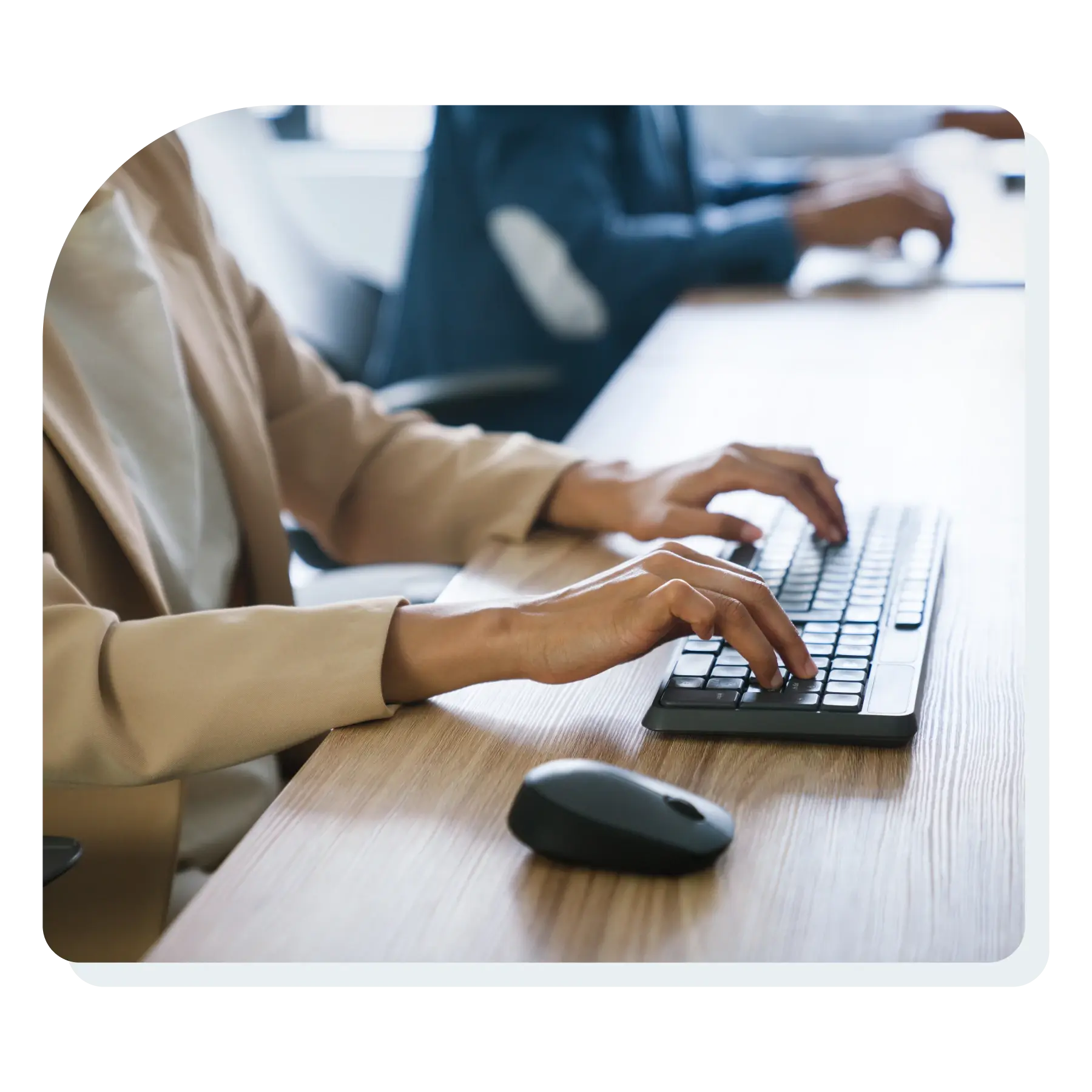 a_woman_typing_on_a_keyboard_in_an_office