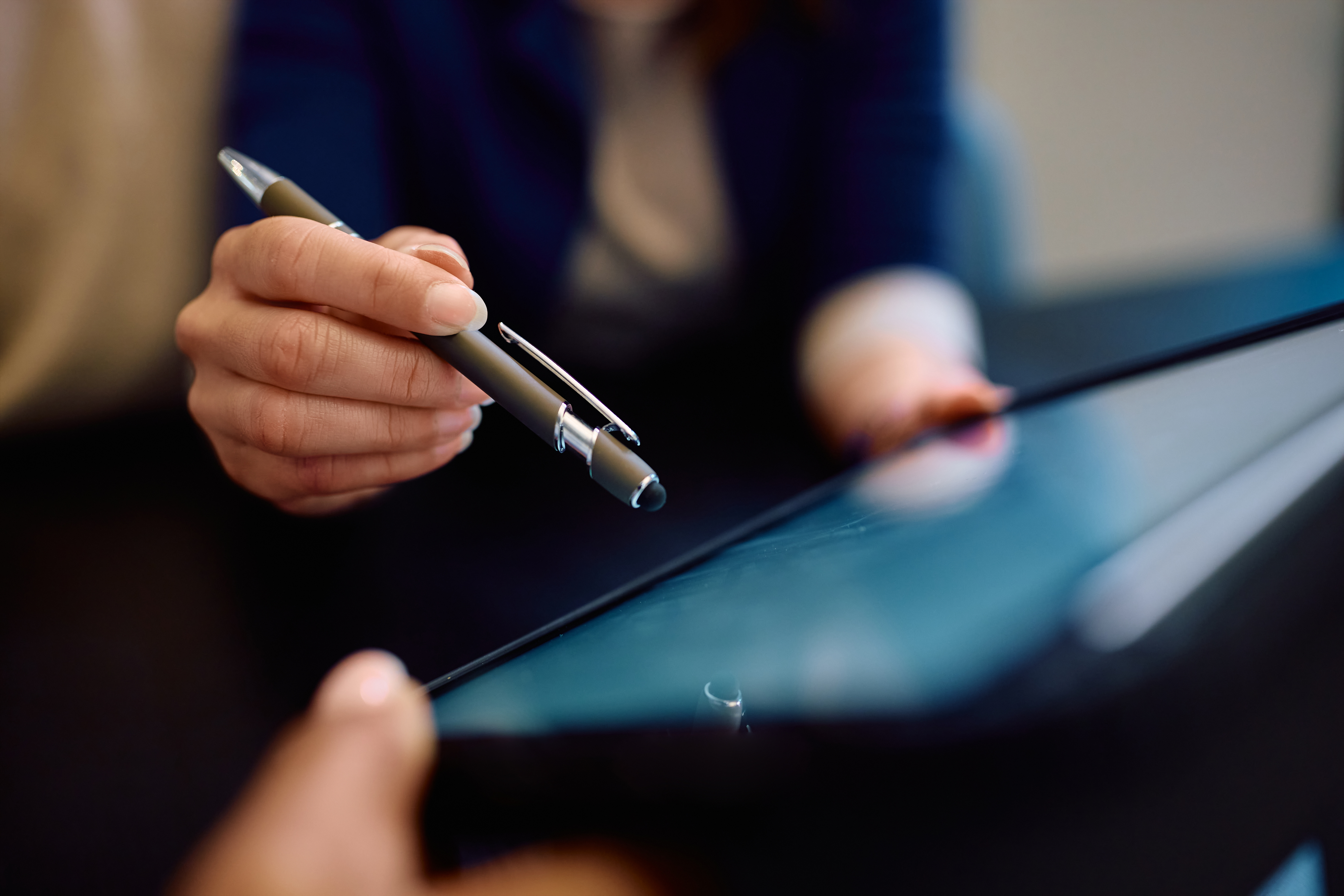 close-up-of-woman-signing-an-agreement-on-touchpad-2023-11-27-05-07-10-utc