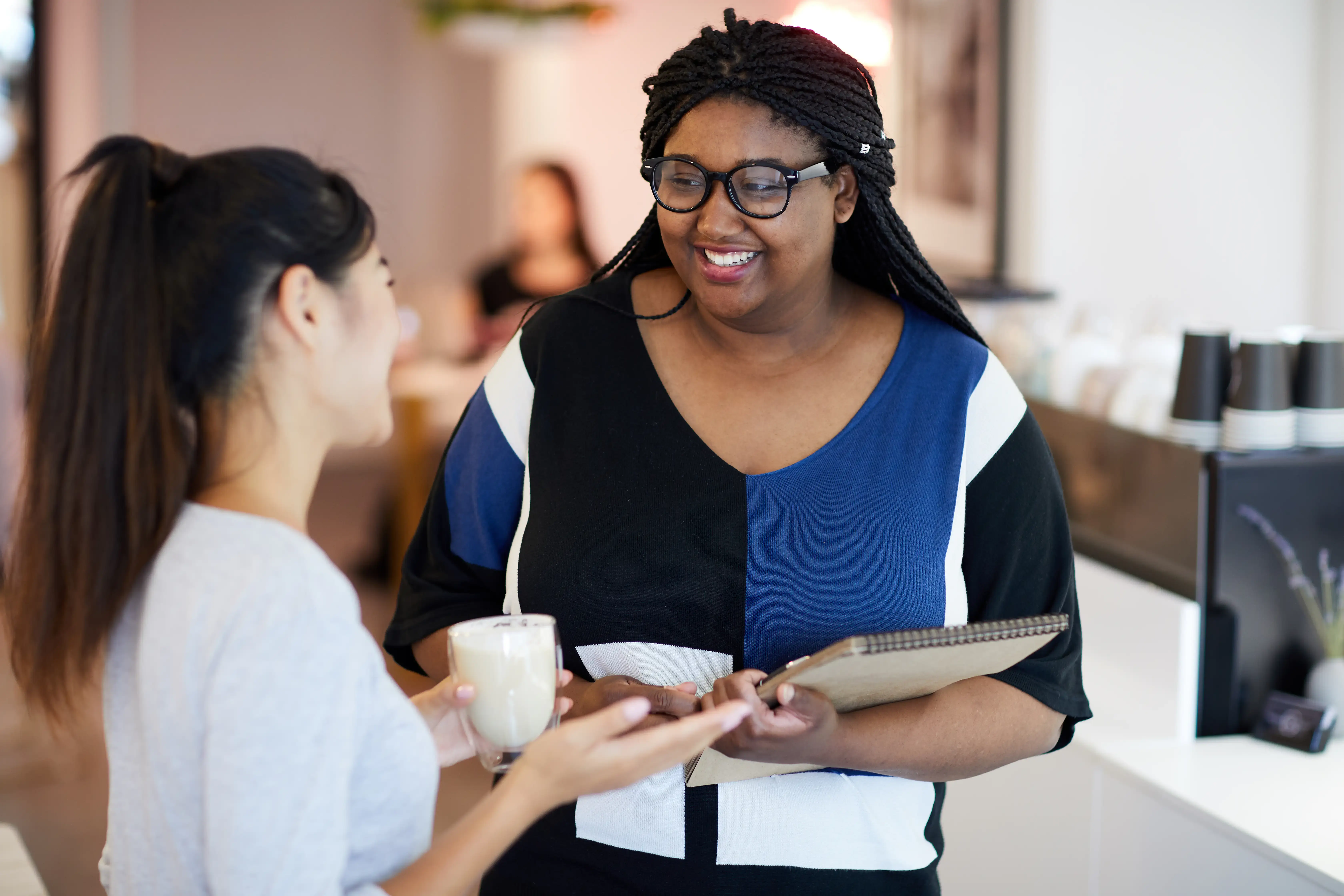 Woman consulting with client in a coffee shop