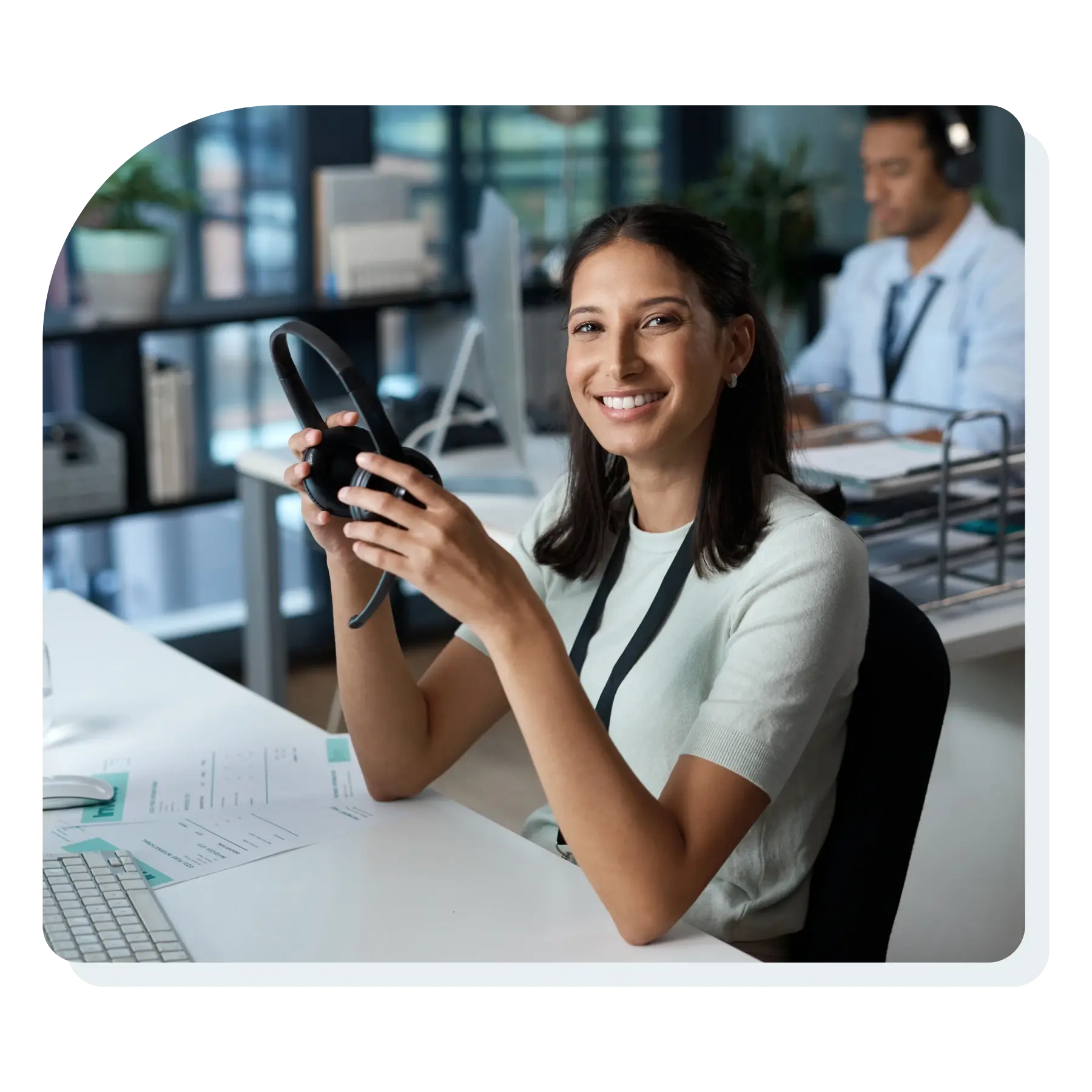 customer_care_woman_smiling_looking_at_camer_at_her_desk