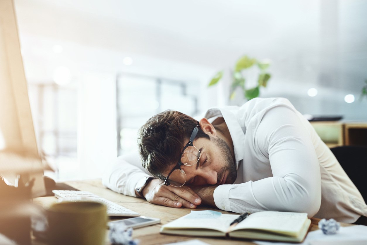 Image of person sleeping at their desk