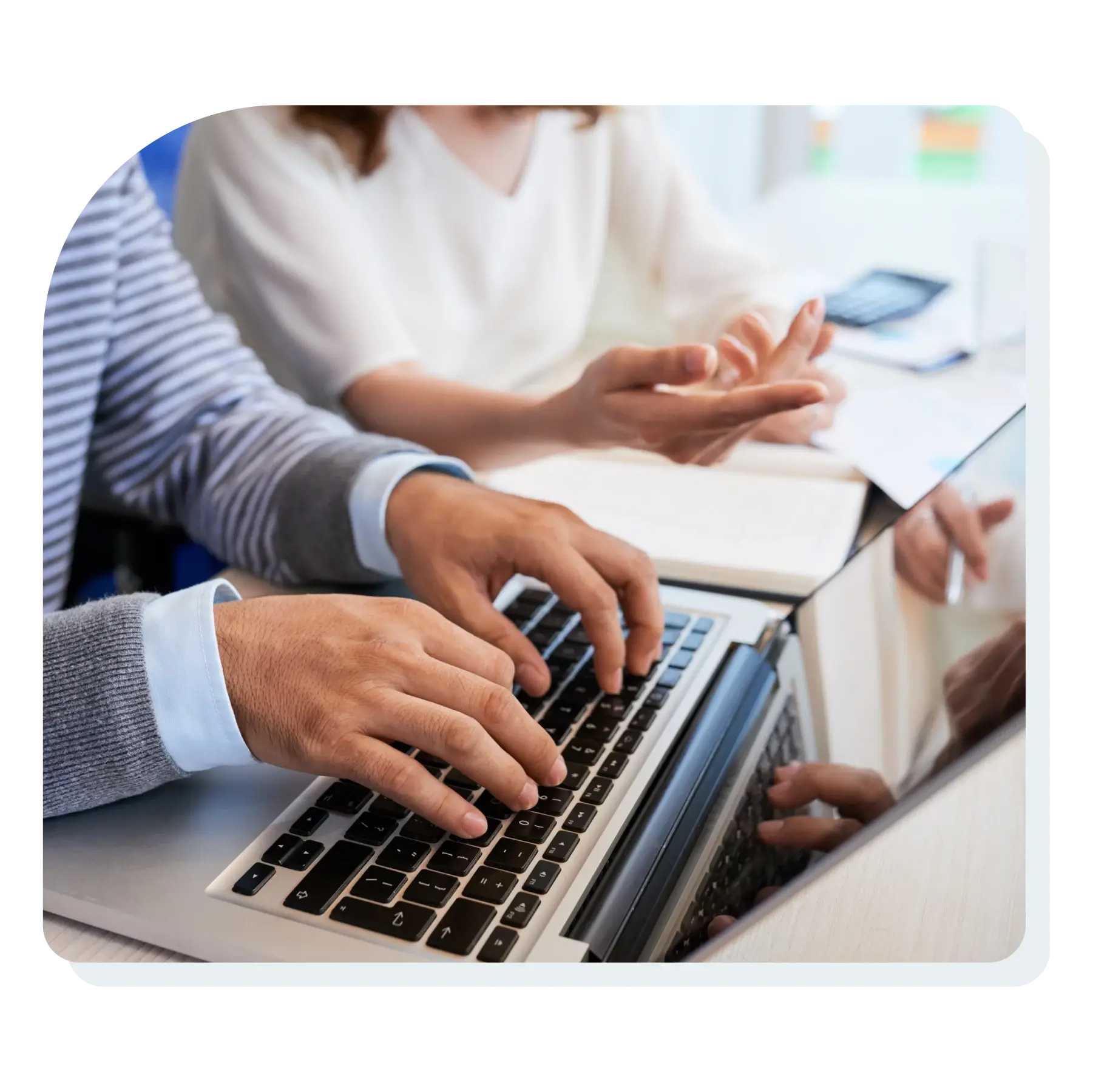 man_and_woman_looking_at_computer_while_the_man_is_typing