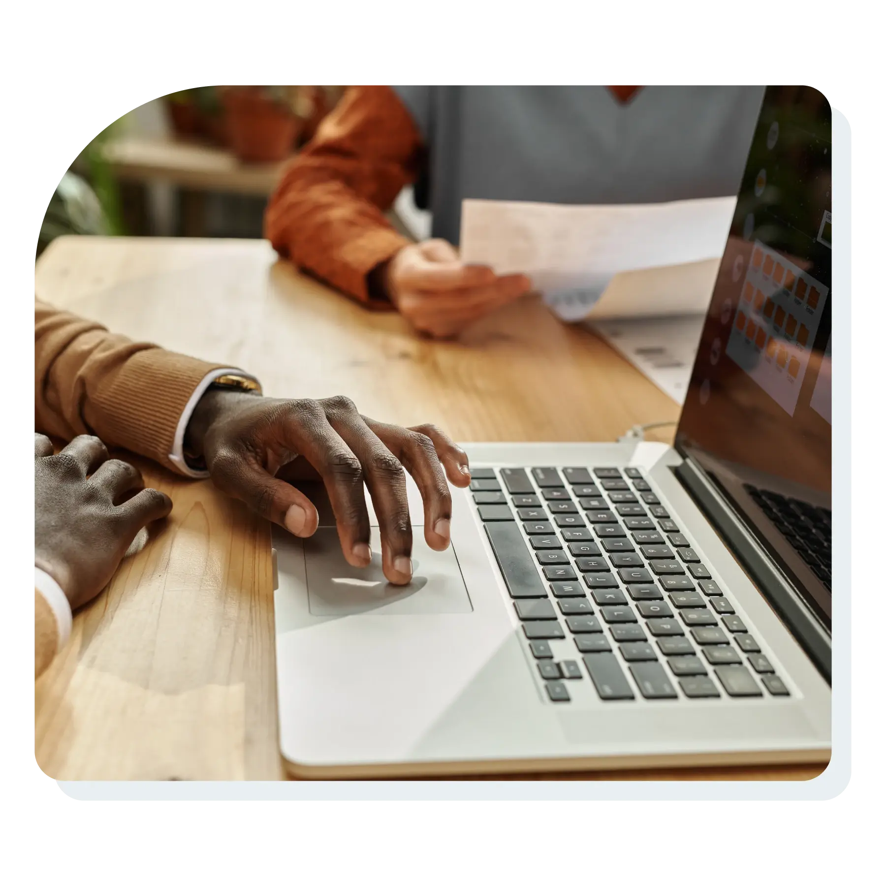 man_on_laptop_moving_documents_around