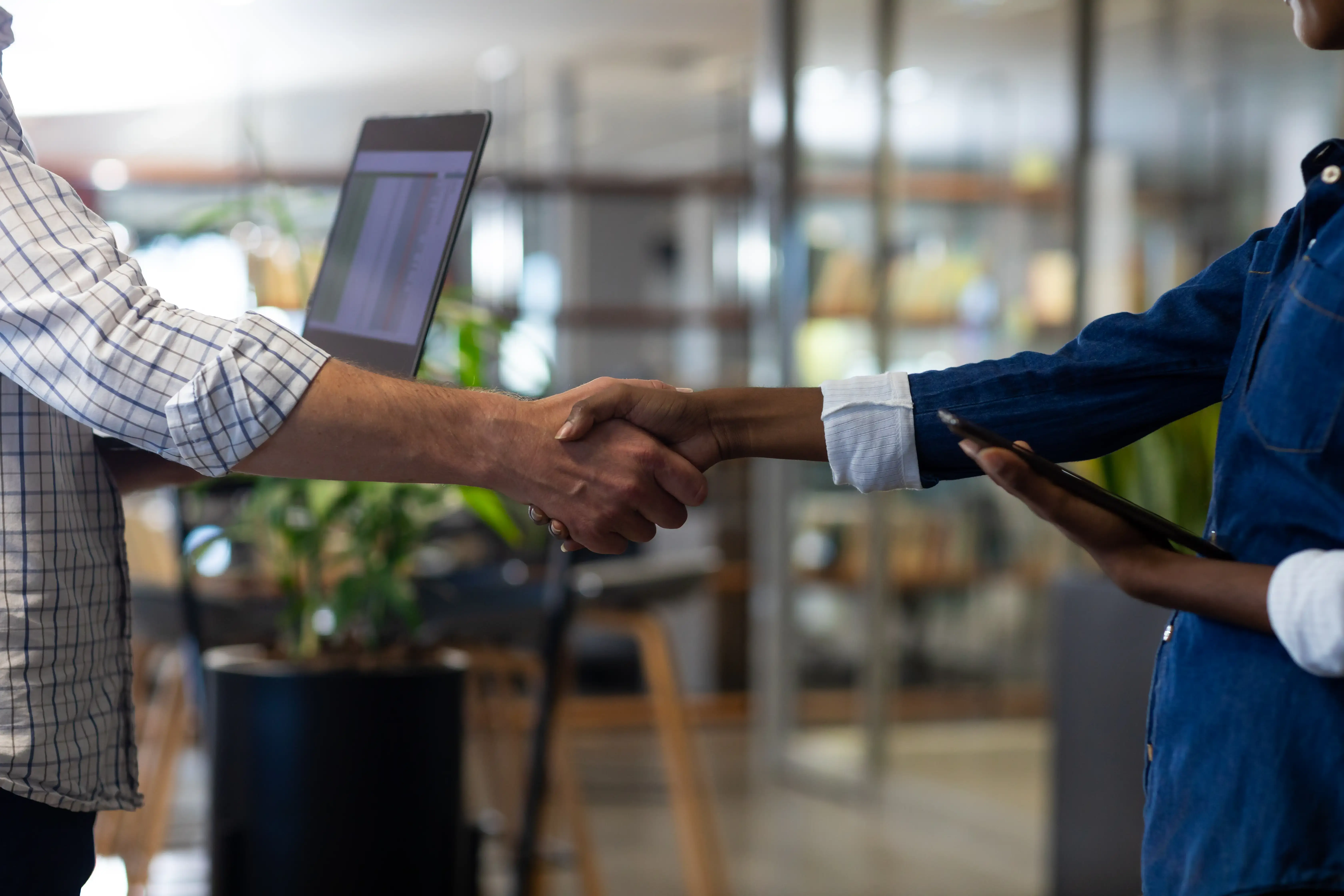 midsection-of-biracial-colleagues-shaking-hands-in-2023-11-27-04-47-33-utc