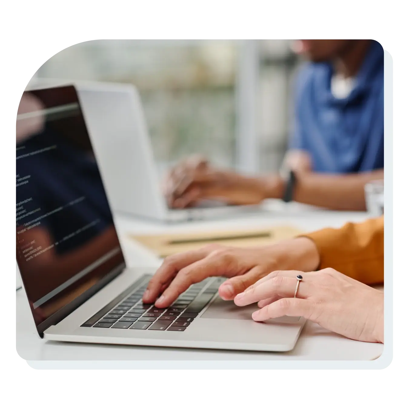 team_or_workers_typing_on_computers