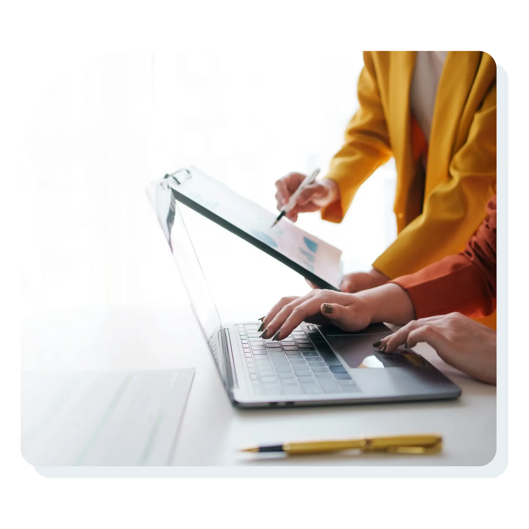 two_women_looking_at_computer_pointing_at_digital_documents