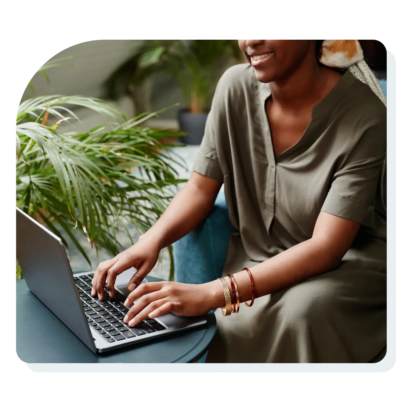 woman_sitting_on_computer_next_to_plant