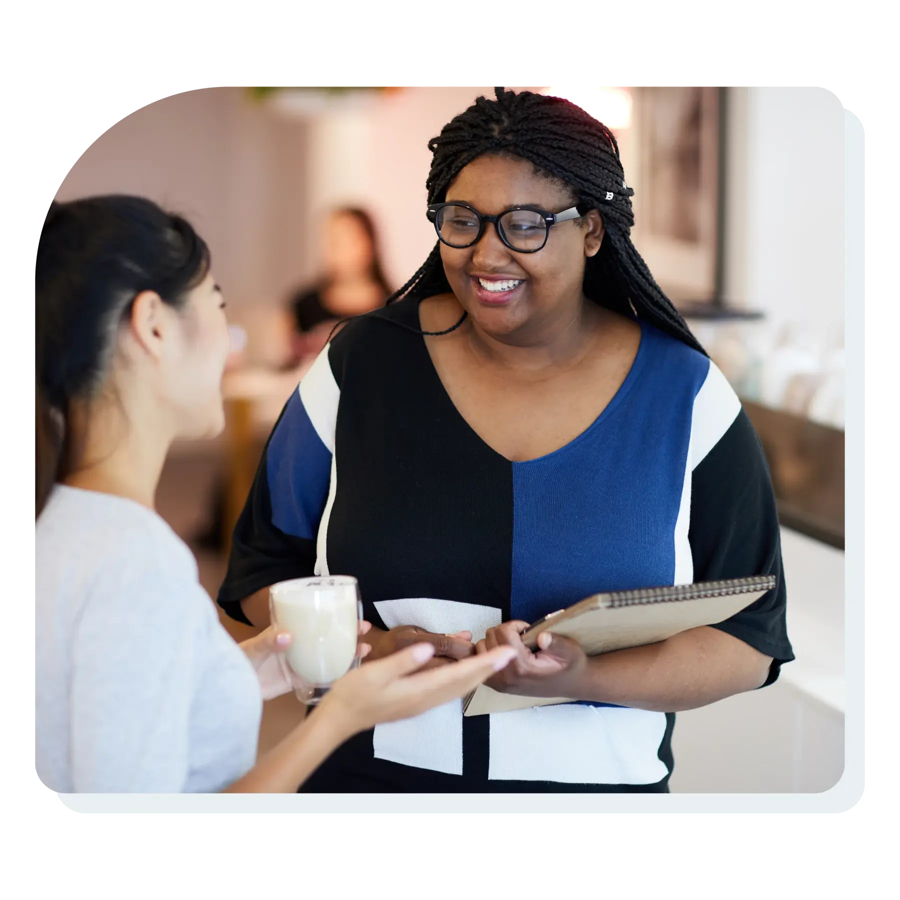 woman_smiling_talking_to_another_woman_customer