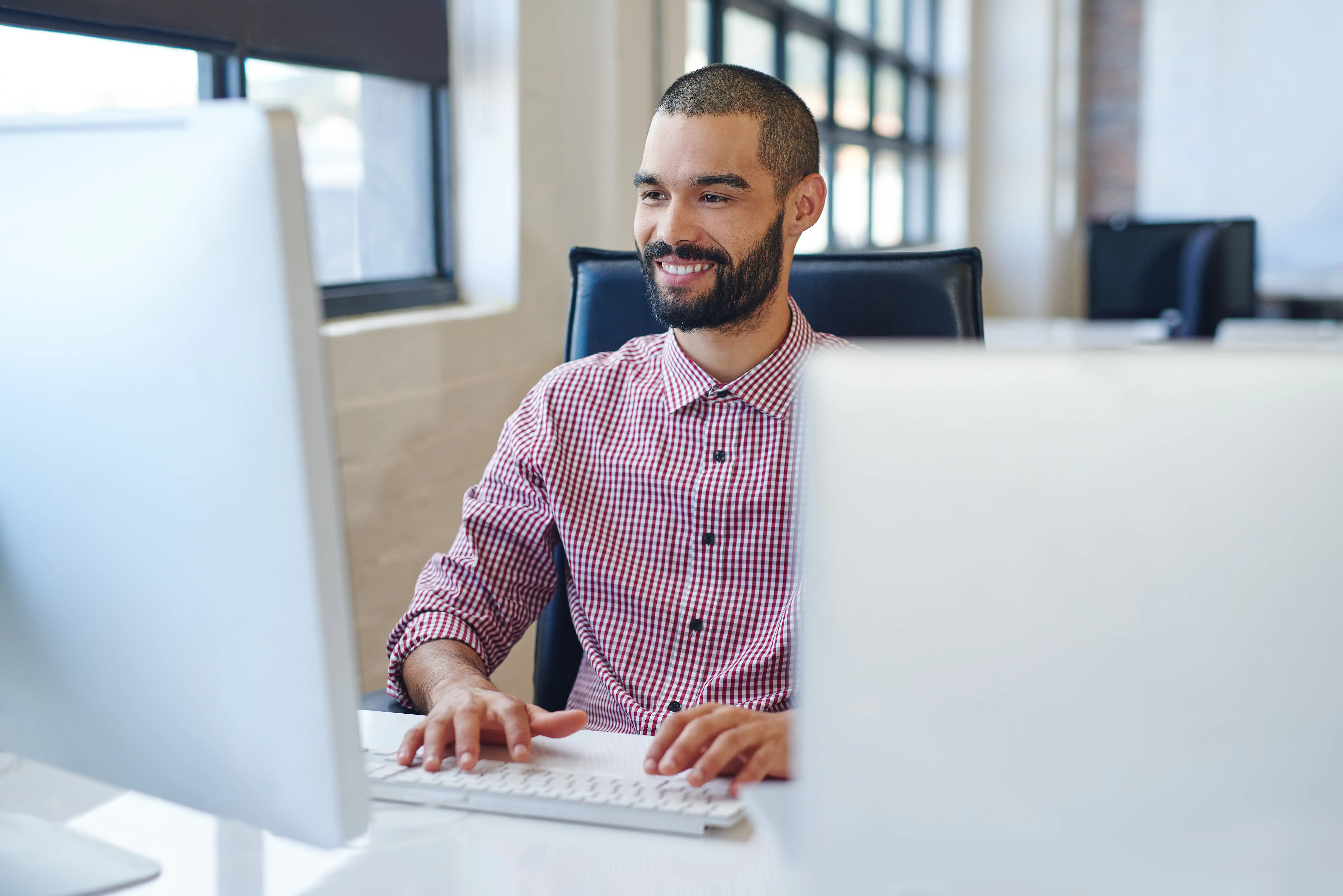 Professional man working at desk on computer