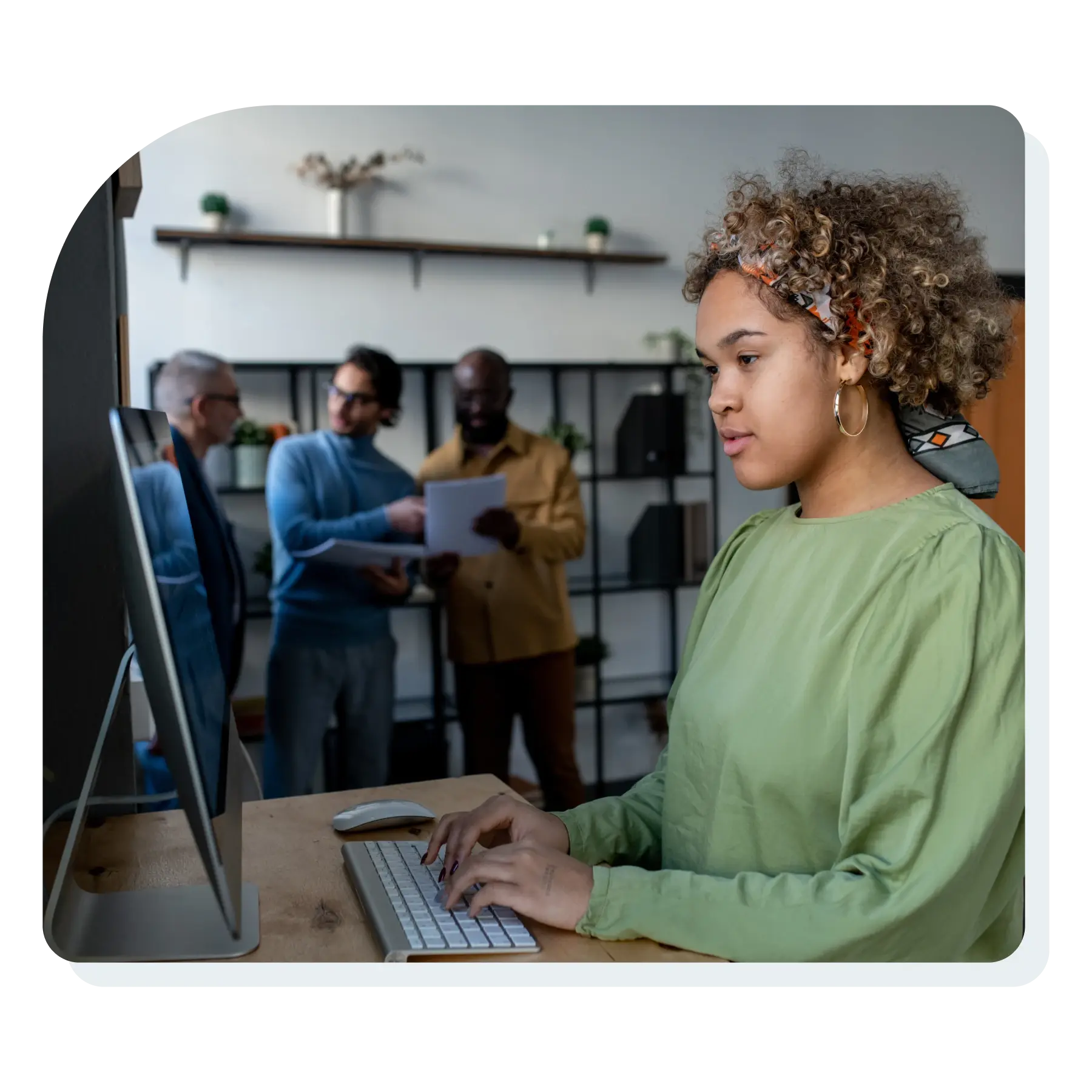 young_pretty_biracial_businesswoman_looking_at_computer_screen